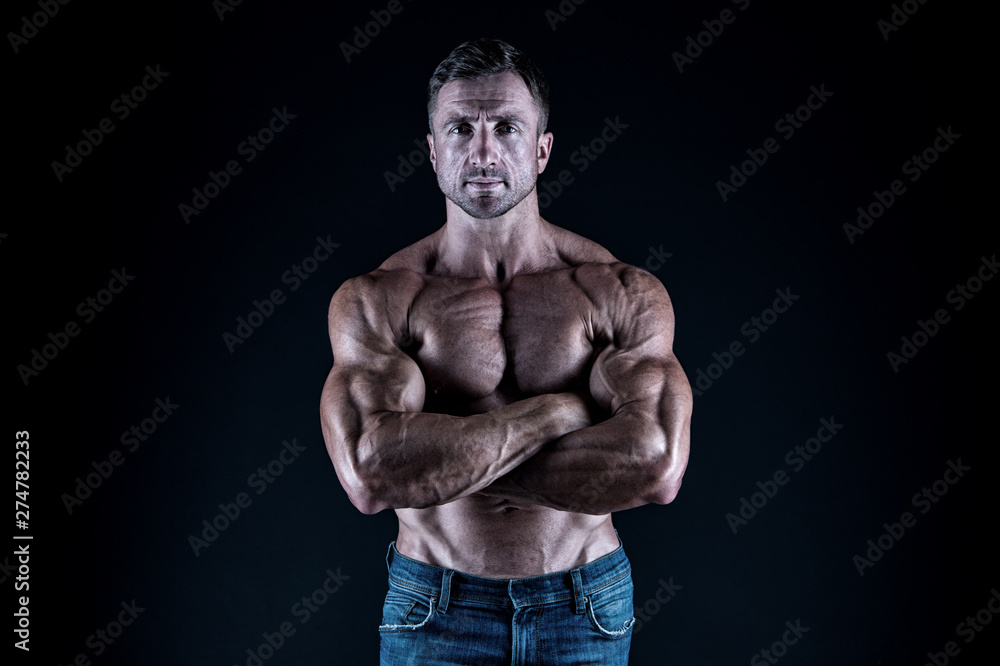 Being enthusiastic for sports. Sportsman or sport man keeping strong arms crossed. Sexy fit man with athletic torso on black background. Taking sports to stay in shape. Physical training and sports