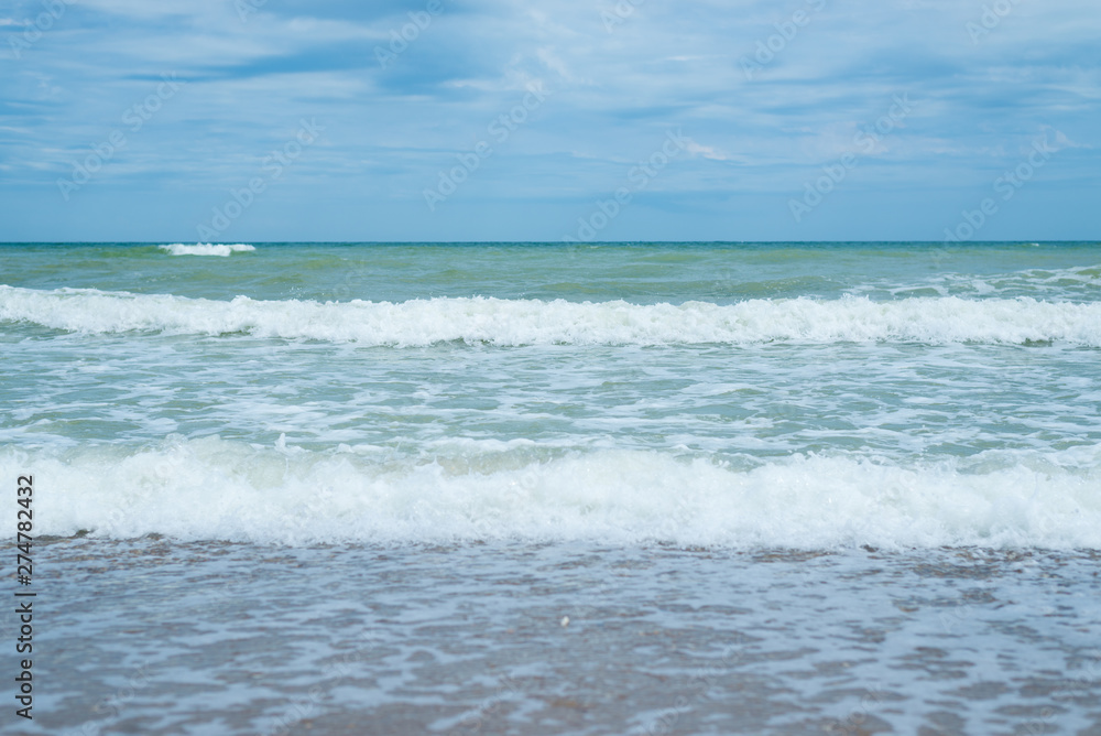 Sea surf on the beach. Waves coming ashore.