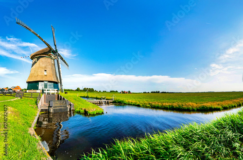 Beautiful windmill in a picturesque landscape near Volendam photo