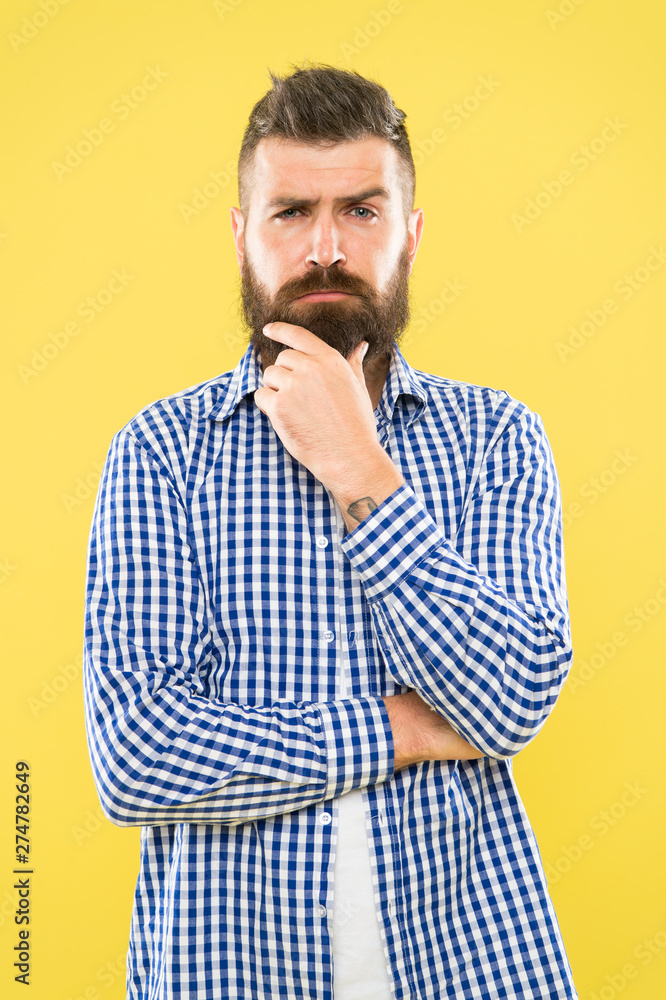 Needing a barber to shape the beard. Bearded man thinking of visiting barber. Thoughtful hipster touching unshaven chin before going to barber shop. Trimming a beard like a master barber Needing a barber to shape the beard. Bearded man thinking of visiting barber. Thoughtful hipster touching unshaven chin before going to barber shop. Trimming a beard like a master barber