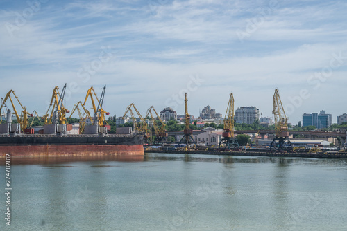 Odessa, Ukraine- June 17, 2019: Sea cargo port with cargo ships and cranes for unloading.