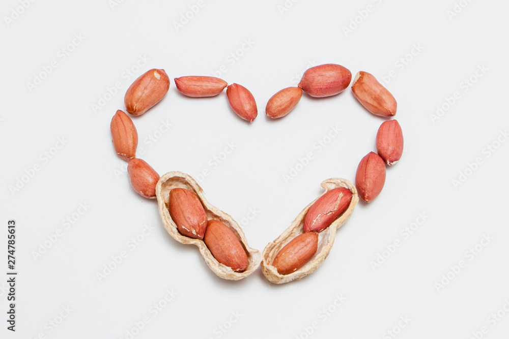 Peanuts, for background or textures. Uncleaned inshell peanuts. Peanuts isolated on white background. Valentine's Day, Flat lay. Copy space. Peanuts, for background or textures. Uncleaned inshell peanuts. Peanuts isolated on white background. Valentine's Day, Flat lay. Copy space.