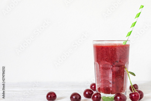 Wallpaper Mural Cherry smoothie in a glass with a straw and fresh berries on white background with copy space. summer drink Torontodigital.ca