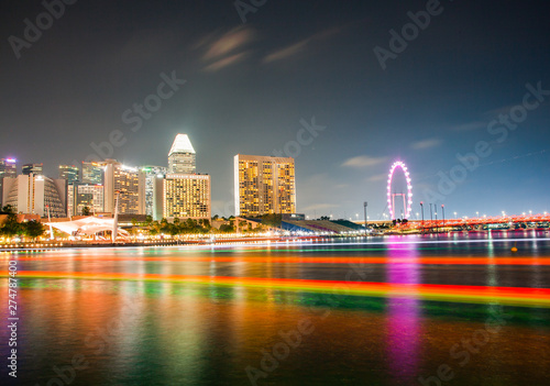 SINGAPORE, SINGAPORE - MARCH 2019: Skyline of Singapore Marina Bay at night with Marina Bay sands, Art Science museum and tourist boats