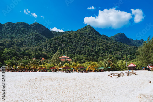 Fototapeta Naklejka Na Ścianę i Meble -  Relaxing on remote paradise beach. Tropical bungalow and luxury house on untouched sandy beach with palms trees in Langkawi Island, Malaysia.