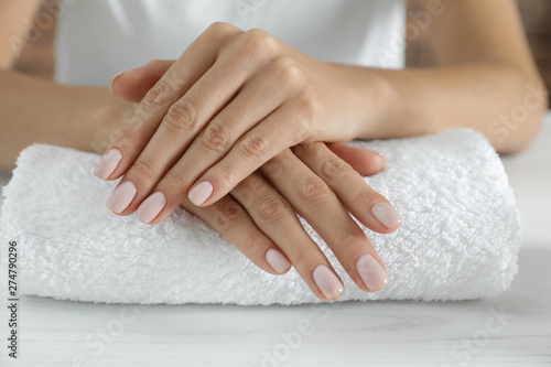Woman showing smooth hands on towel, closeup. Spa treatment photo