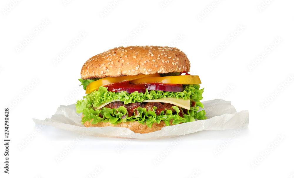 Parchment with tasty fresh burger isolated on white Parchment with tasty fresh burger isolated on white