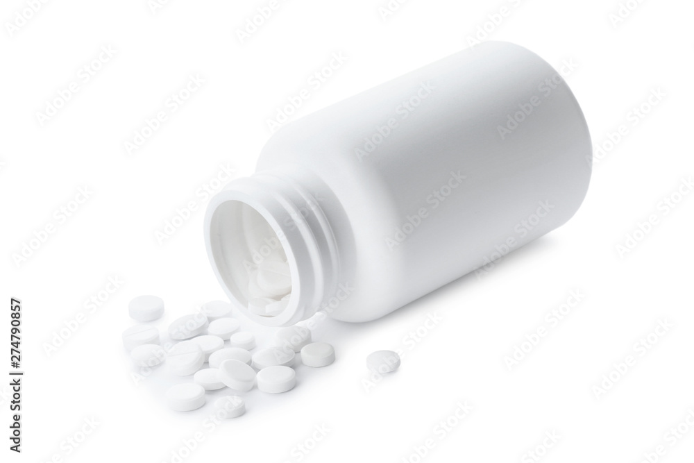 Scattered pills and open container isolated on white Scattered pills and open container isolated on white