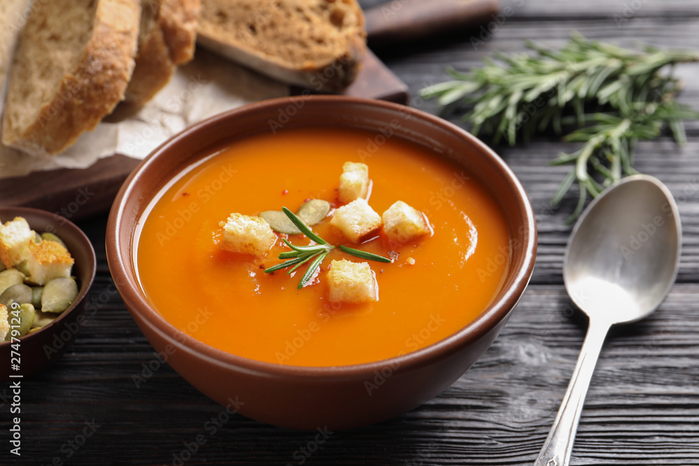 Bowl of tasty sweet potato soup served on table Bowl of tasty sweet potato soup served on table