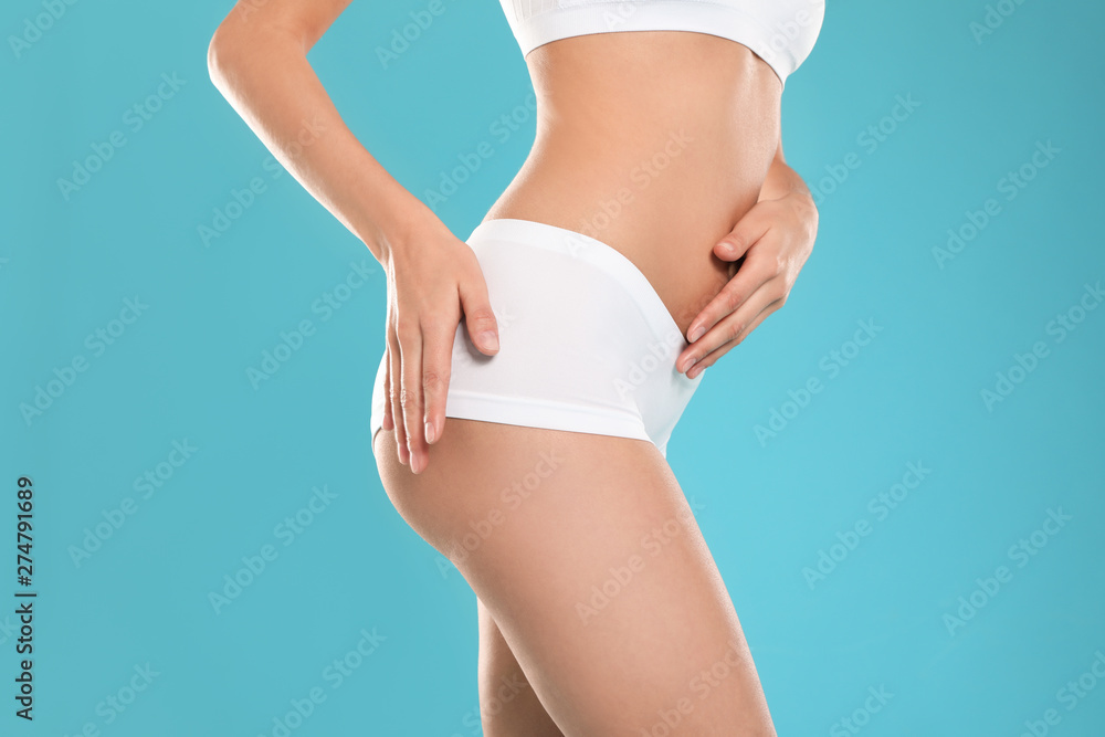 Fototapeta premium Slim young woman with smooth gentle skin on color background, closeup. Beauty and body care concept