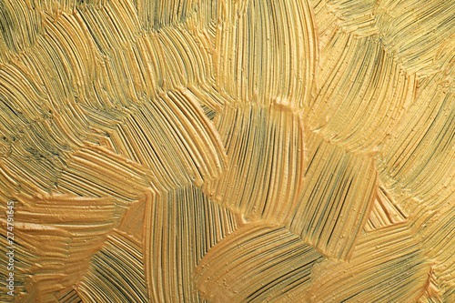Golden paint brush strokes as background, closeup