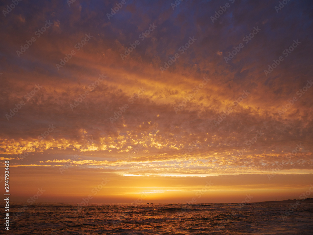 Vivid colorful sky at sunset over the ocean in Portugal