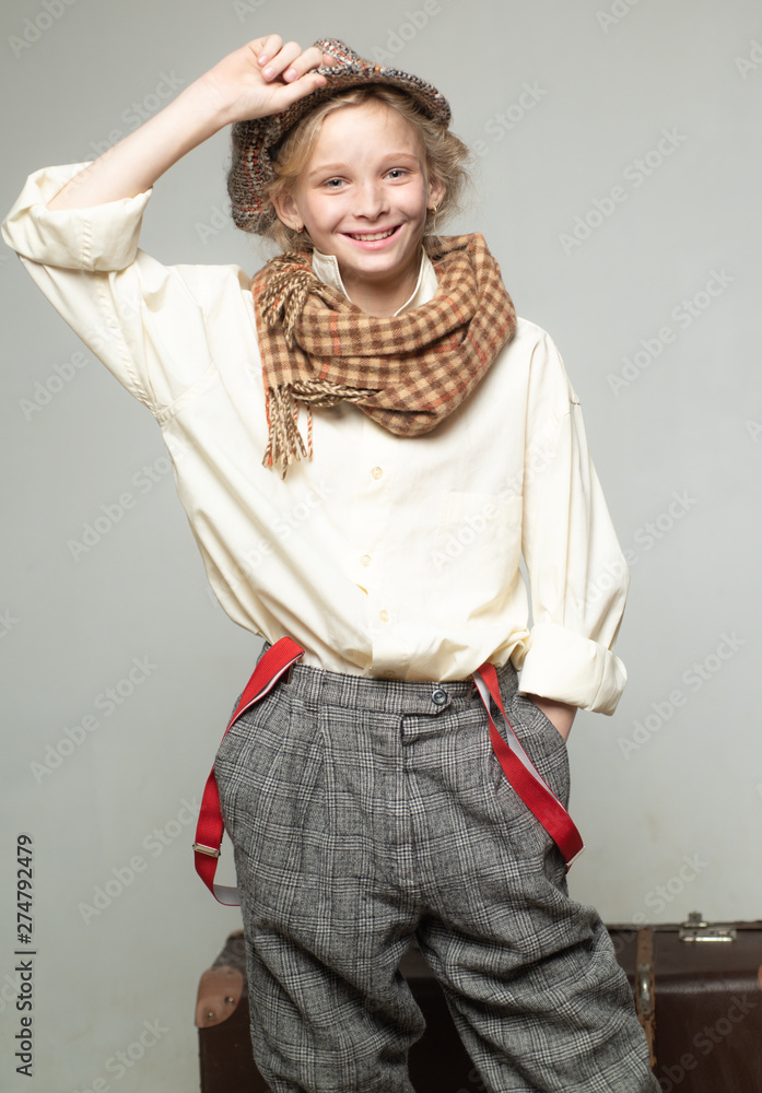 teen girl in retro male suit. retro fashion model. Vintage suspender. old fashioned child in beret. street kid with dirty face. vintage english style. Travel with old suitcase. Homelss. traveling - obrazy, fototapety, plakaty 