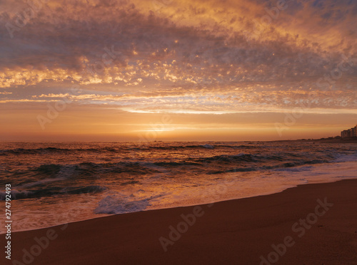 Wide angle view over beach at sunset in Portugal with beautiful clouds © Barry