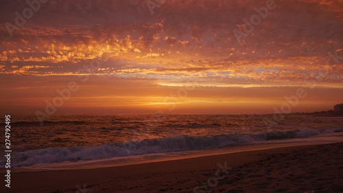 Wide angle view over beach at sunset in Portugal with beautiful clouds © Barry