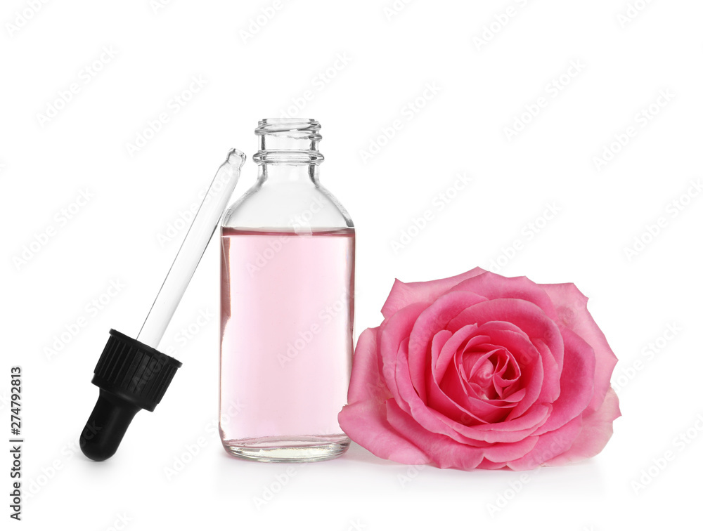 Bottle of rose essential oil, pipette and flower isolated on white Bottle of rose essential oil, pipette and flower isolated on white