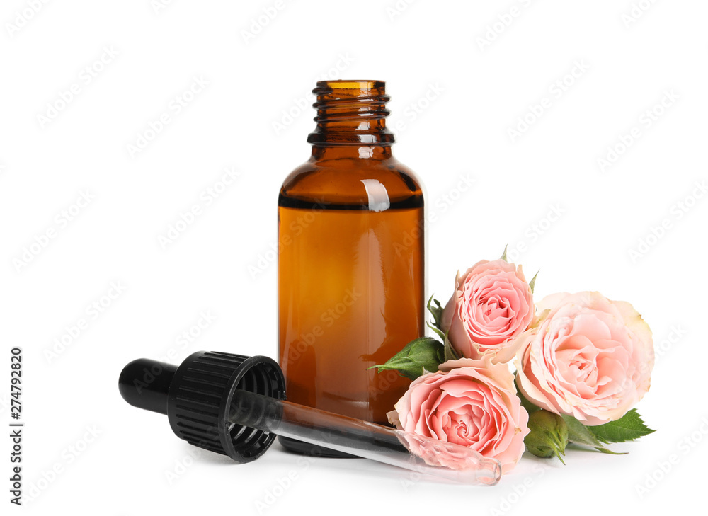 Bottle of rose essential oil and flowers isolated on white Bottle of rose essential oil and flowers isolated on white