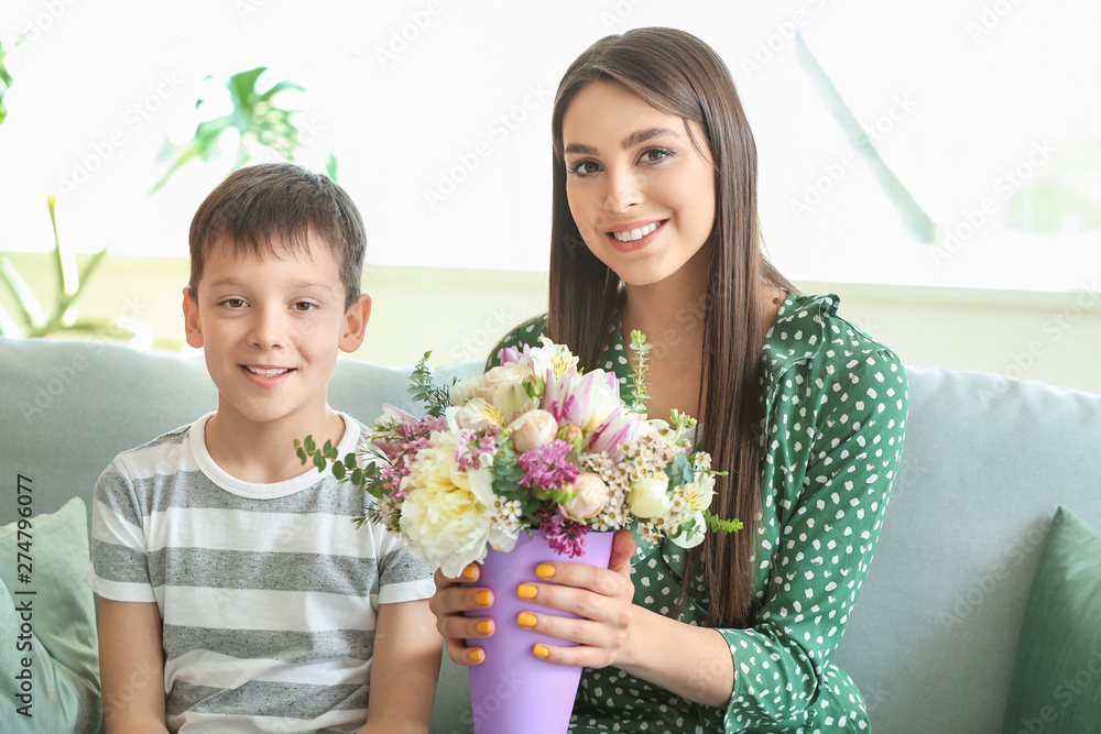 Young mother and son with bouquet of beautiful flowers at home Young mother and son with bouquet of beautiful flowers at home