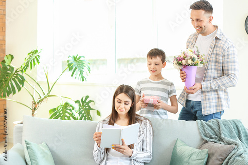 Family greeting young woman...