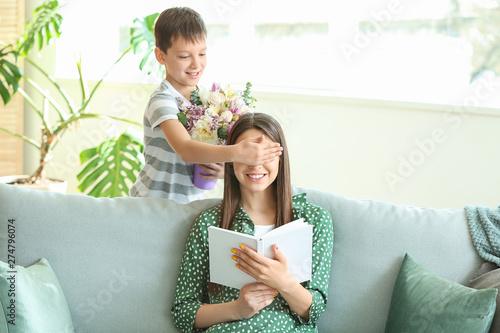 Little son greeting his mot...