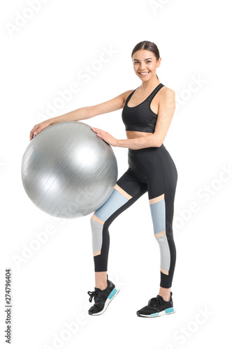 Young sporty woman with fitball on white background