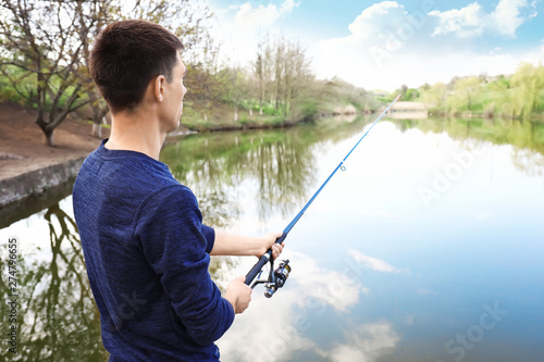 Young man fishing in river