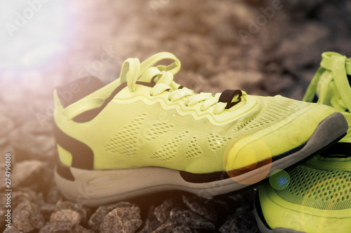 Trail running shoes in a park, close-up sneakers. Running shoes before practice. Sport active lifestyle concept. Horizontal photo banner for website header design. Sun beam lights