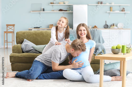 Beautiful pregnant woman with her family at home