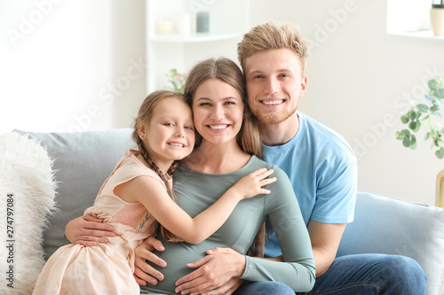 Beautiful pregnant woman with her family at home