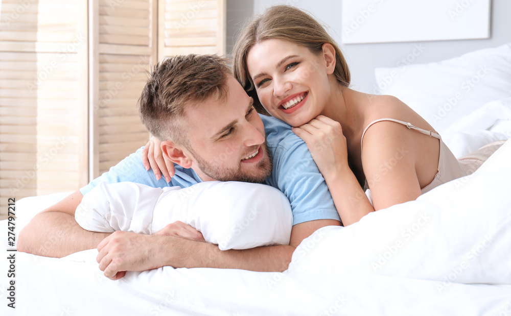 Portrait of happy young couple in bedroom Portrait of happy young couple in bedroom
