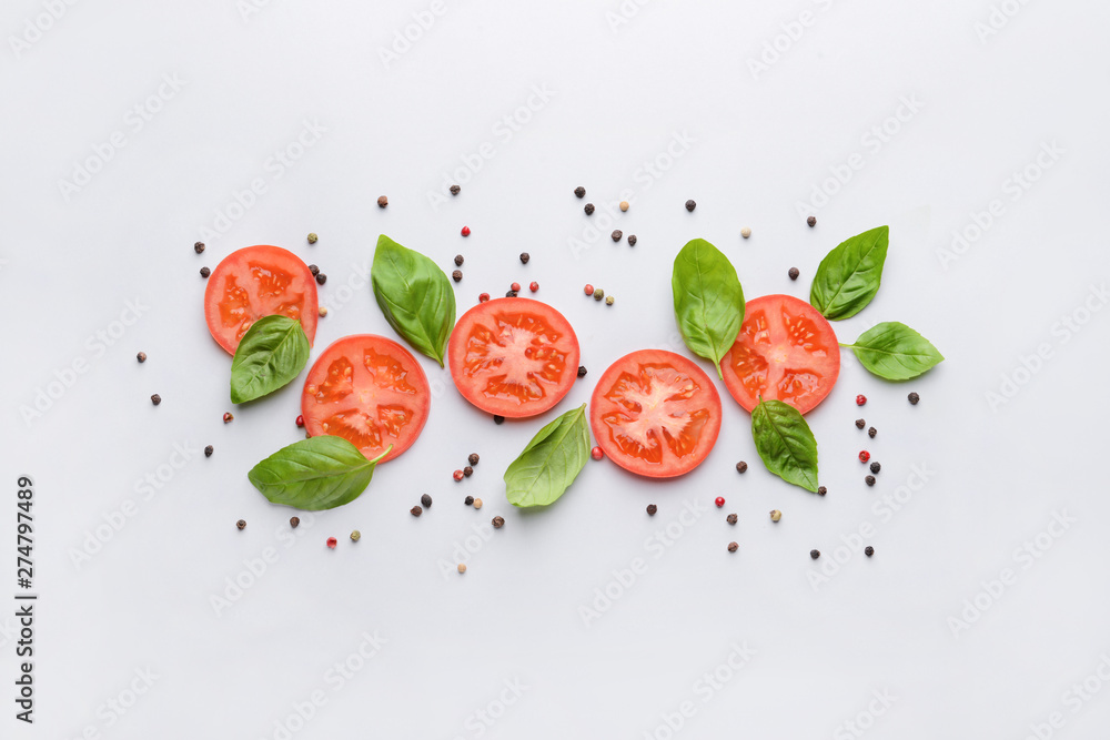 Fototapeta Fresh basil, tomato and spices on light background