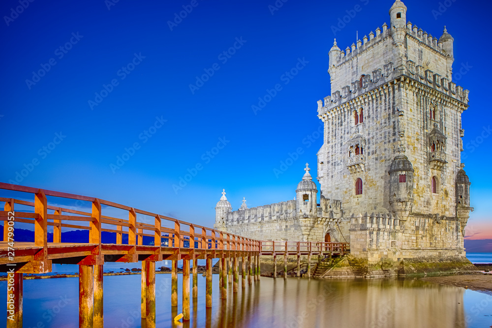 Ancient Belem Tower on Tagus River in Lisbon at Blue Hour in Portugal.