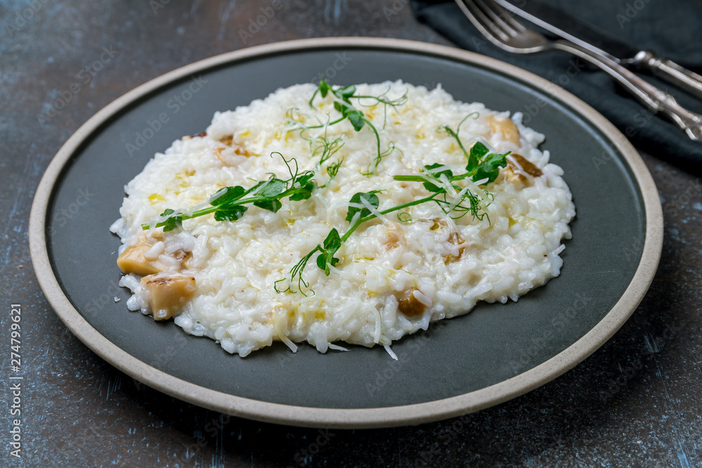 risotto with porcini mushrooms on grey plate risotto with porcini mushrooms on grey plate