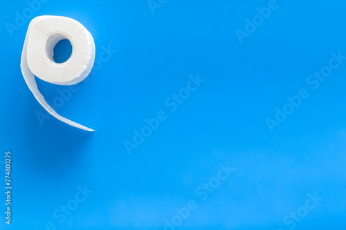 Toilet paper for proctology diseases concept on blue background top view mockup