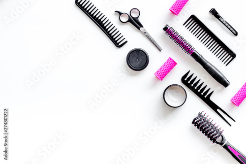 professional pink accessories of hairdresser with combs and sciccors on work desk white background top view copyspace