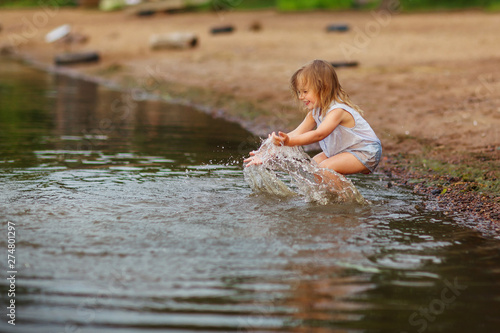 Little girl playing in the lake