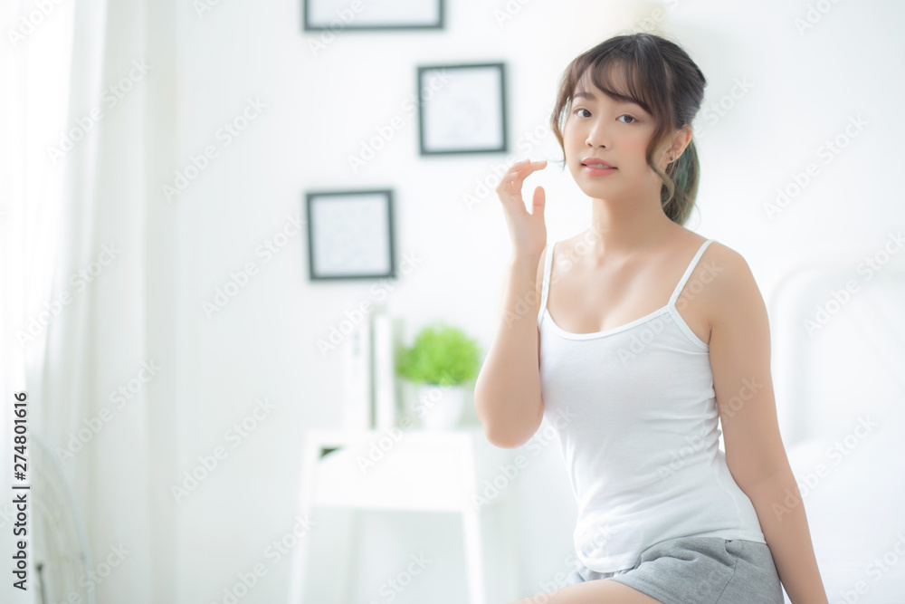 Portrait of beautiful young asian woman smile while wake up healthy and wellness with sunrise at morning in the bedroom, asia girl skin care with happy with fresh, lifestyle and relax concept. Portrait of beautiful young asian woman smile while wake up healthy and wellness with sunrise at morning in the bedroom, asia girl skin care with happy with fresh, lifestyle and relax concept.