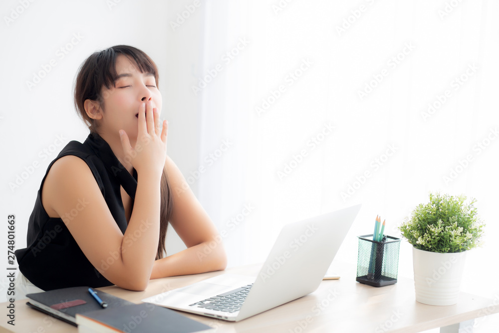 beautiful young freelance asian woman working bored and tired on laptop computer at the office, girl lazy sleepy and yawning on notebook, female secretary with exhausted, business concept. beautiful young freelance asian woman working bored and tired on laptop computer at the office, girl lazy sleepy and yawning on notebook, female secretary with exhausted, business concept.