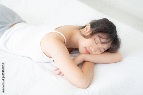 Beautiful asian young woman smile sleeping lying on bed with comfortable and happy leisure at bedroom, beauty asia girl wellness with relax and fresh for health concept.