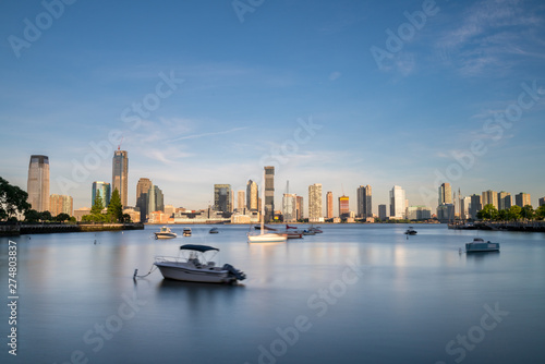 Long Exposure View of New Jersy Shoreline with Boats in the Foreground