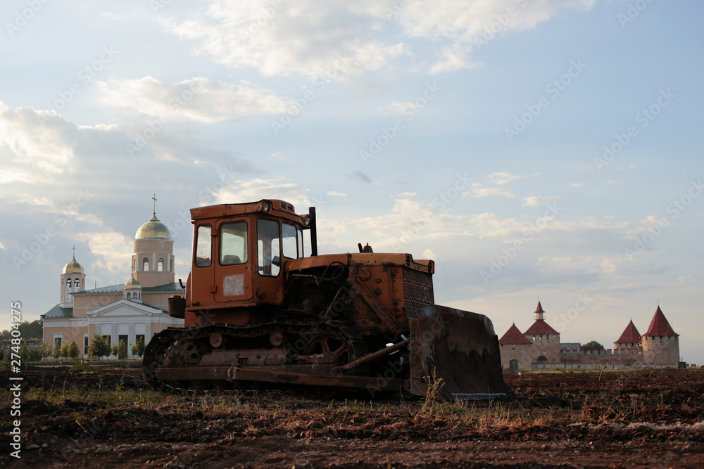Fototapeta premium Bender fortress. Construction and restoration work with the help of an archaic bulldozer of the USSR. Ottoman stronghold (citadel) on the banks of the Dniester.