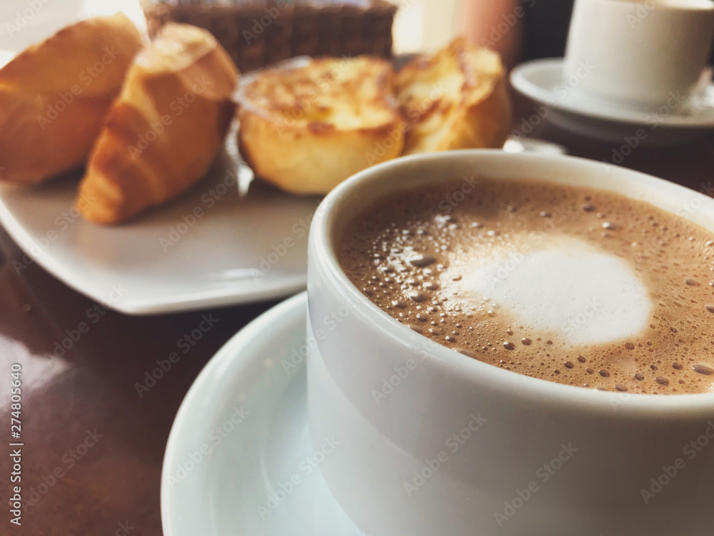 Brazilian breakfast. Capuccino cup and toasted bread with butter background. Brazilian breakfast. Capuccino cup and toasted bread with butter background.