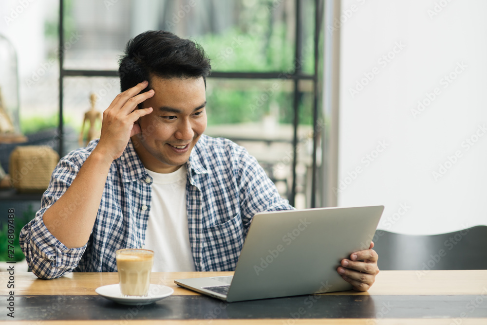 Smart Asian man working with laptop in cafe, work concept and copy space. Smart Asian man working with laptop in cafe, work concept and copy space.