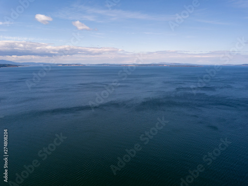 Open ocean with clouds and mountains