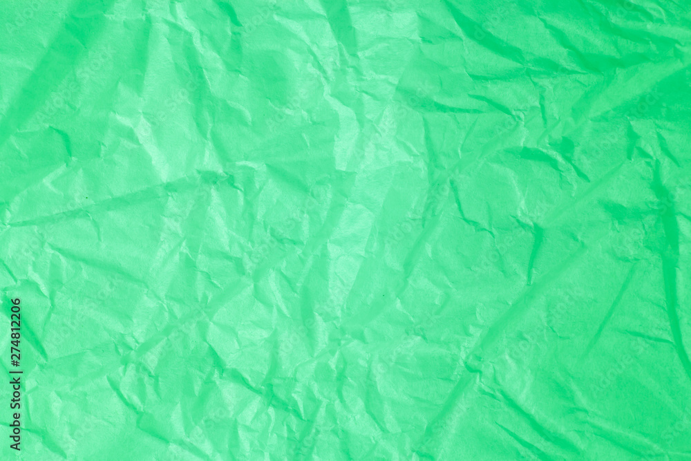 Fototapeta premium Green crumpled paper background.