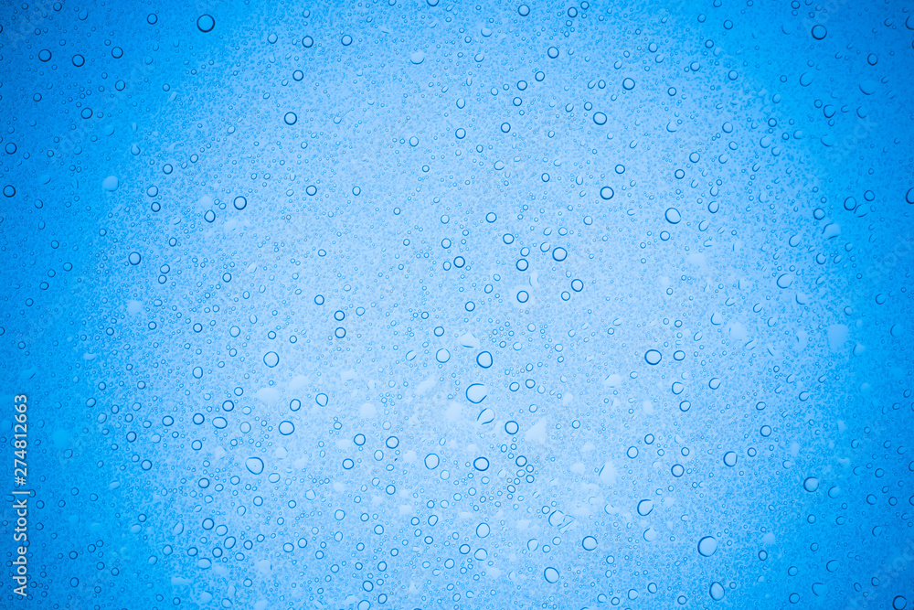 Rain droplets on blue glass background, Water drops on glass. Rain droplets on blue glass background, Water drops on glass.