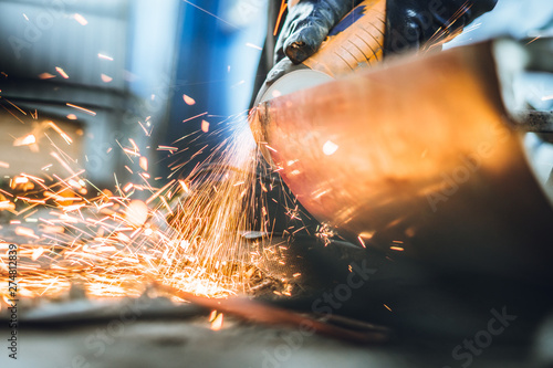 Iron workers saw sparks worker sawing the iron