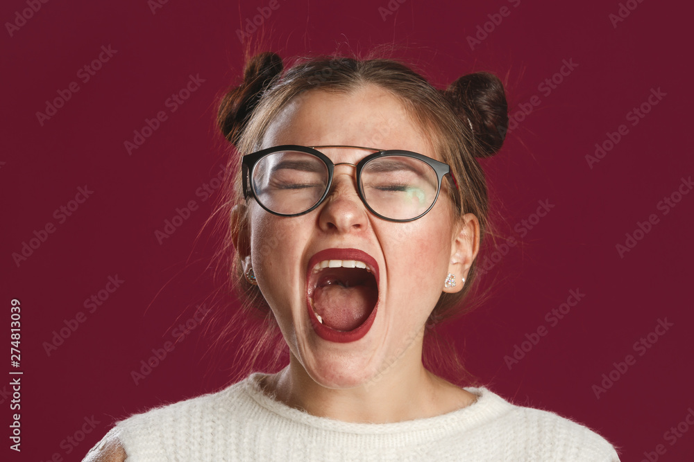 Studio close-up shot of a positive flirtatious young European woman with dark eyes, smiling happily, blinking at the camera in a playful manner, flirting with you. Studio close-up shot of a positive flirtatious young European woman with dark eyes, smiling happily, blinking at the camera in a playful manner, flirting with you.