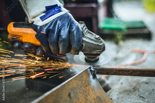 Iron workers saw sparks worker sawing the iron