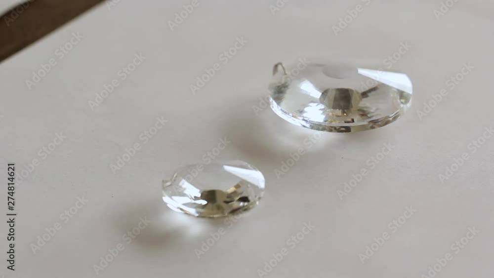 Close up beads of glass crystal in a white background - transparent crystal refraction Close up beads of glass crystal in a white background - transparent crystal refraction